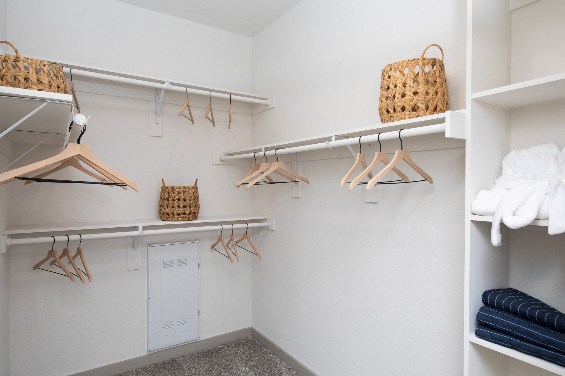a spacious walk in closet with shelves at a senior apartment community